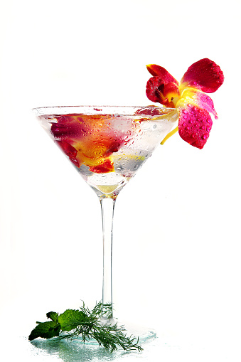 Glass of delicious fruit non-alcoholic cocktail on a bright background with an umbrella. Health drinks. Copy space
