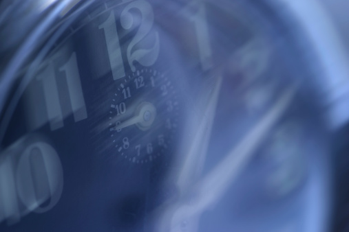 alarm clock face in blue with numbers blurred
