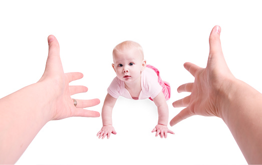 Arms reaching out encouraging baby to crawl