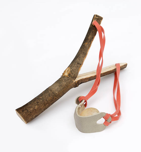 A catapult made of wood and a ball of clay.