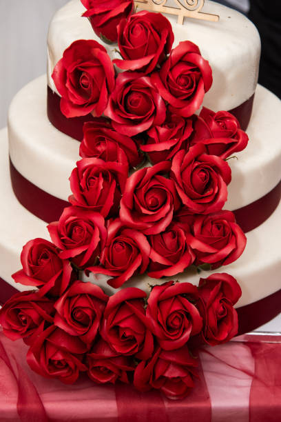 istock Wedding cake decorated with red  roses 1726584437