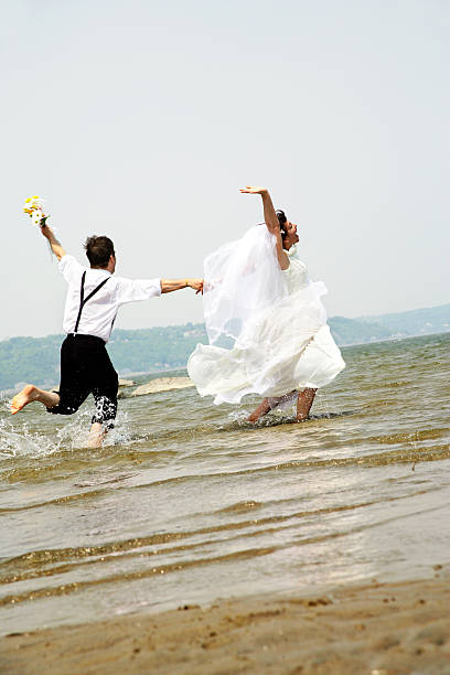 istock Just married running in  water 172658750
