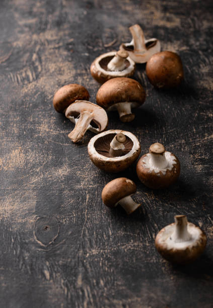 istock Raw champignon mushrooms on black background 1726596654