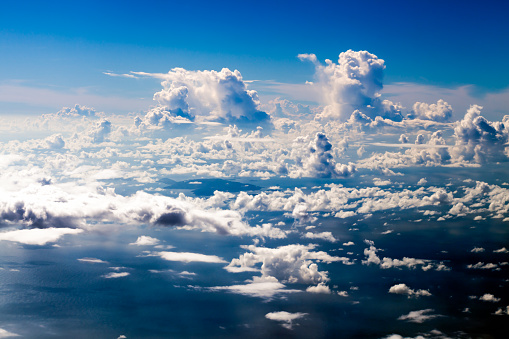 Bright blue sky with large white clouds.