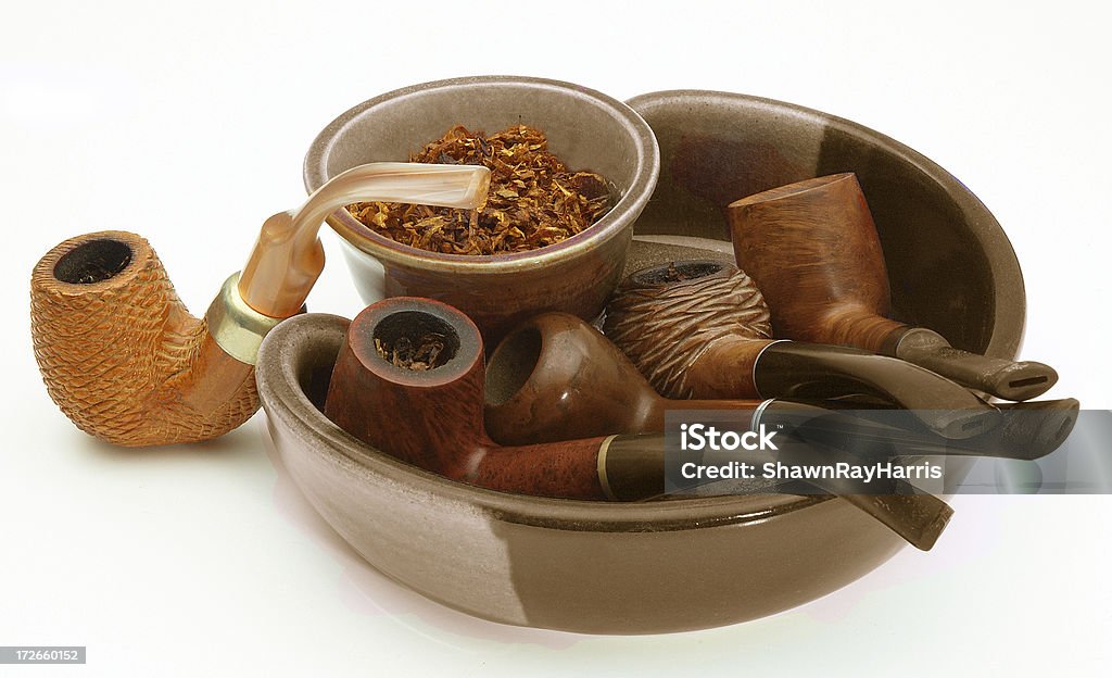 Tobacco Tray Five pipes gathered in a still life with tobacco. Addiction Stock Photo