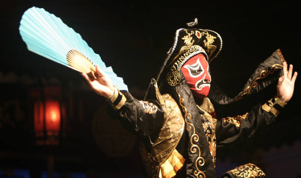 Chinese Opera Performer Chinese Opera Actor wearing traditional costumes with designs dating back from the 17th Century. sichuan province stock pictures, royalty-free photos & images