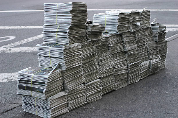 Huge pile of free newspapers downtown in New York city