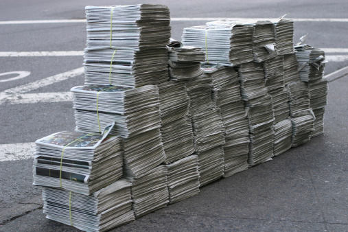 Huge pile of free newspapers