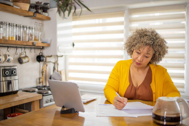 istock Senior woman is going through bills and finances 1726619829