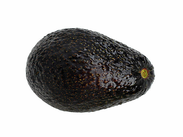 avocado "A ripe avocado, isolated on white." hass avocado stock pictures, royalty-free photos & images