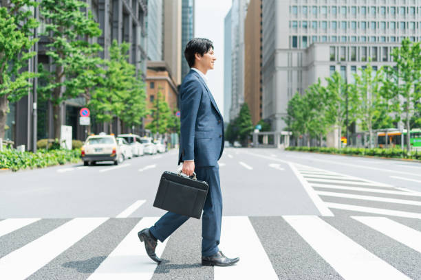 istock Young businessman crossing a pedestrian crossing 1726622493