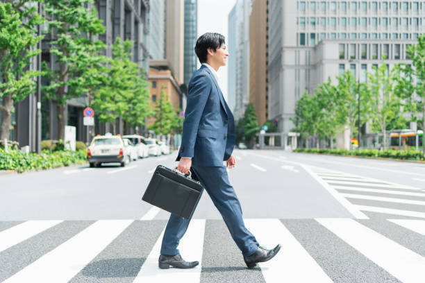 istock Young businessman crossing a pedestrian crossing 1726625670