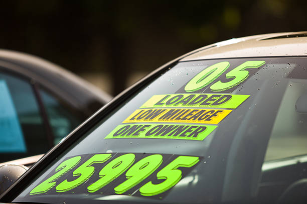 Used Car Dealership Stickers on the windshield of a car for sale at a used car dealership car for sale stock pictures, royalty-free photos & images