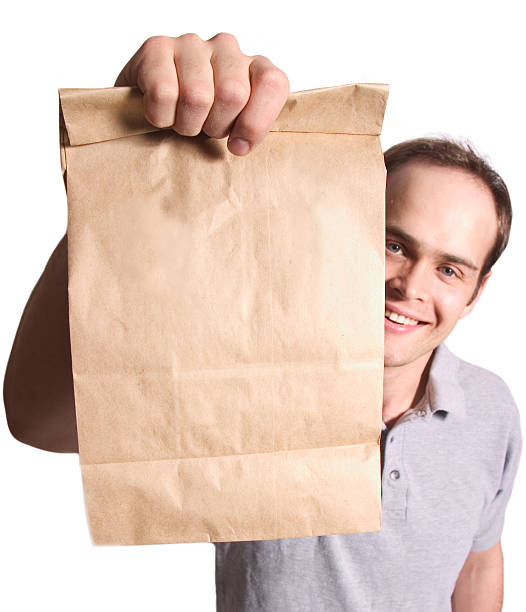 A man holding out a bag. Shallow dof...bag is in focus.