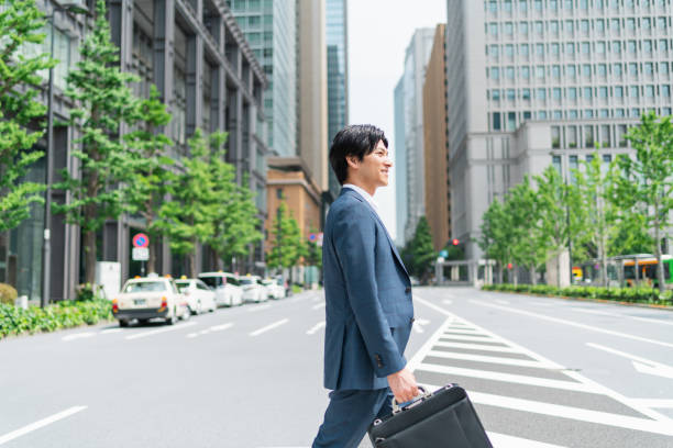 istock Young businessman crossing a pedestrian crossing 1726628444