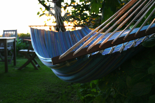 Hammock and table with chairs in garden. Taken June 2005. Check out the light on the ropes - it's quite beautiful!