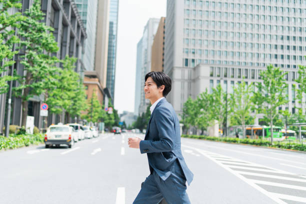 istock Young businessman crossing a pedestrian crossing 1726629569