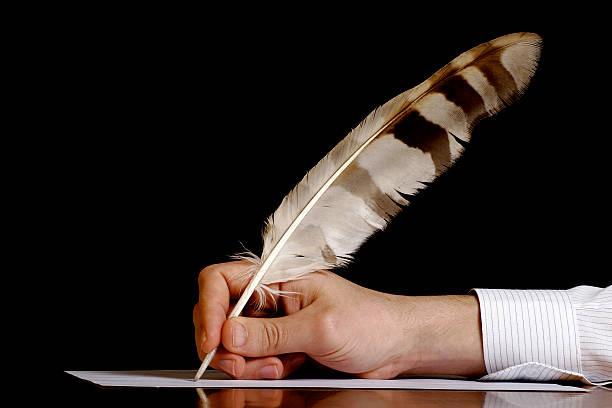 Author at work "A hand writing with a feather pen, isolated on black. Much space for copy" the human body writing black human hand stock pictures, royalty-free photos & images