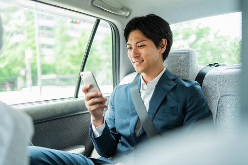 Young businessman in a cab