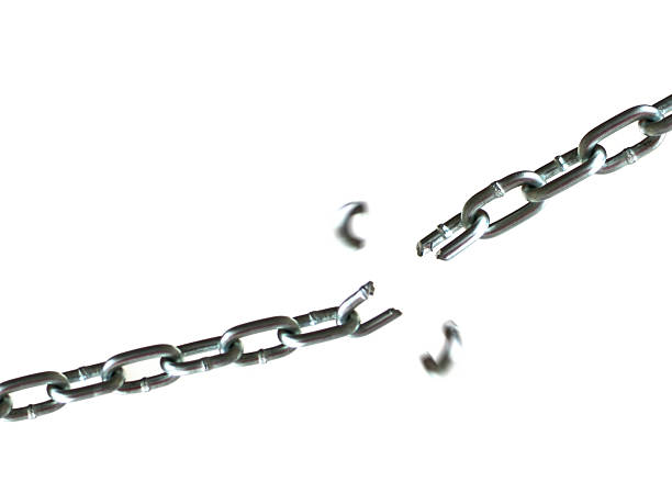 Breaking Chain Chain breaking isolated on white.  Pieces are blured from motion chain is in focus. broken chain stock pictures, royalty-free photos & images