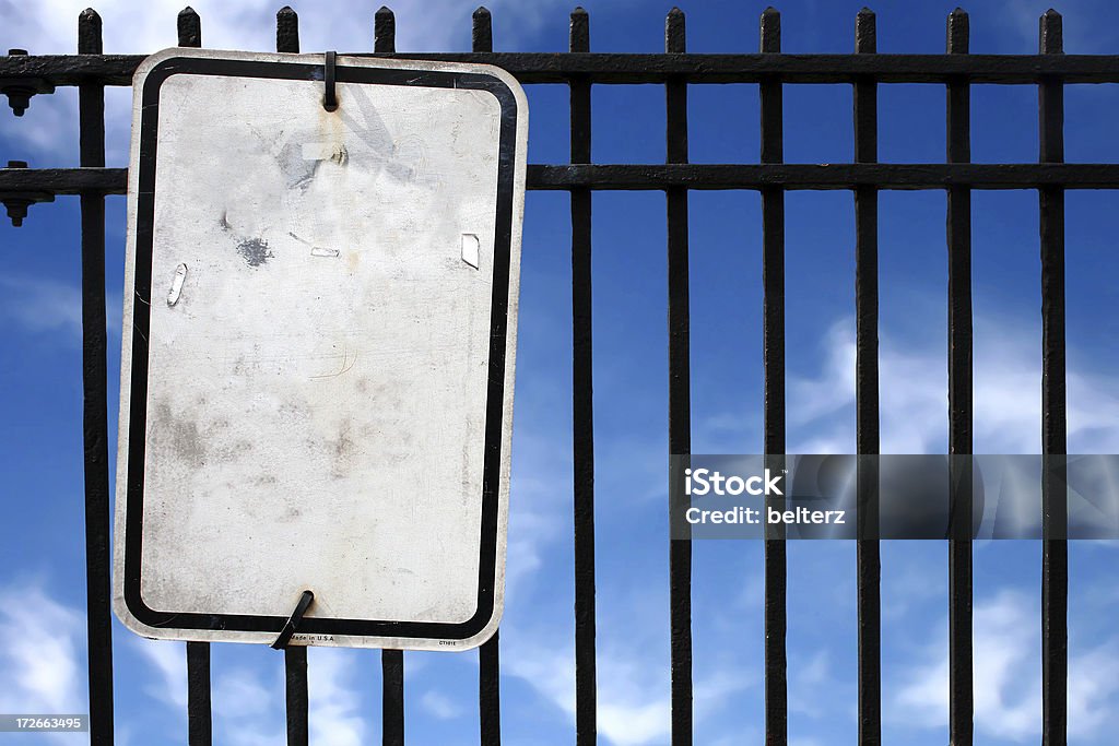 blank sign and fence "a blank sign, fence and blue sky background" Advertisement Stock Photo