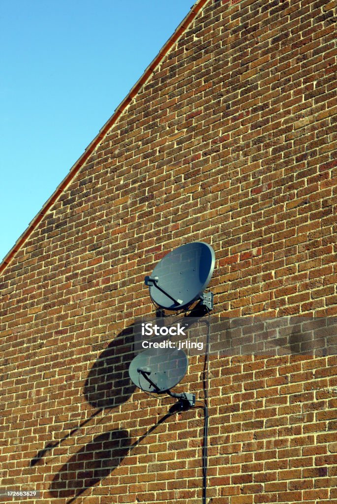 Two Sky Dishes Two Sky Dishes on side of building London Antenna - Aerial Stock Photo