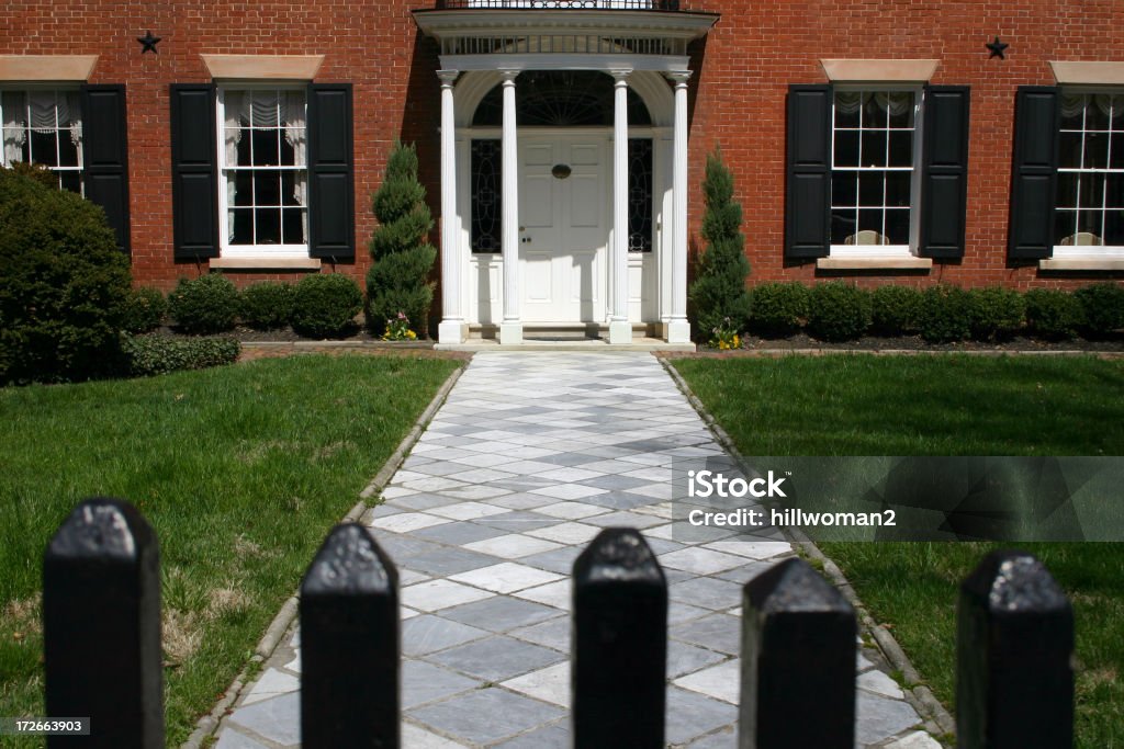 Federal Home shot of a federal style home shot from the gate in early afternoon Home Front Stock Photo