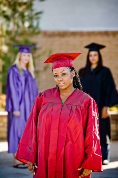 istock graduation girls with red gown in front 172664346