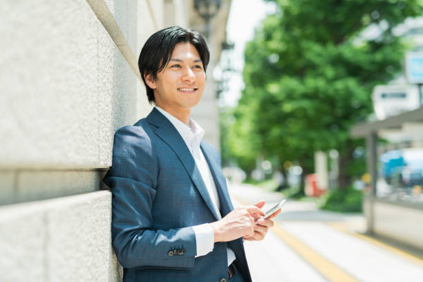 istock Young businessman checking his smartphone by the building 1726647674