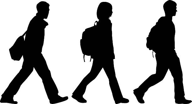 istock A silhouette of three students on their way to school 172664782