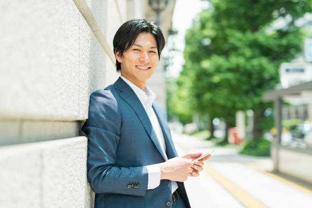 istock Young businessman checking his smartphone by the building 1726649552