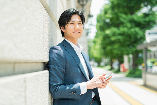 istock Young businessman checking his smartphone by the building 1726651757