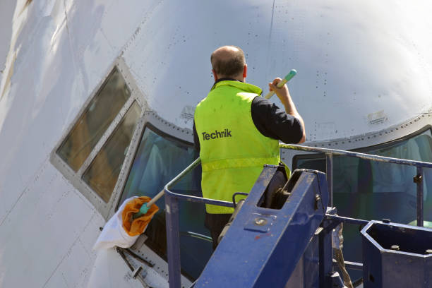 Cleaning an airplane´s cockpit window stock photo