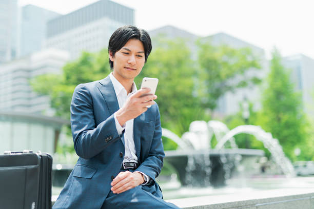 istock Young businessman checking his smartphone in the park 1726661182