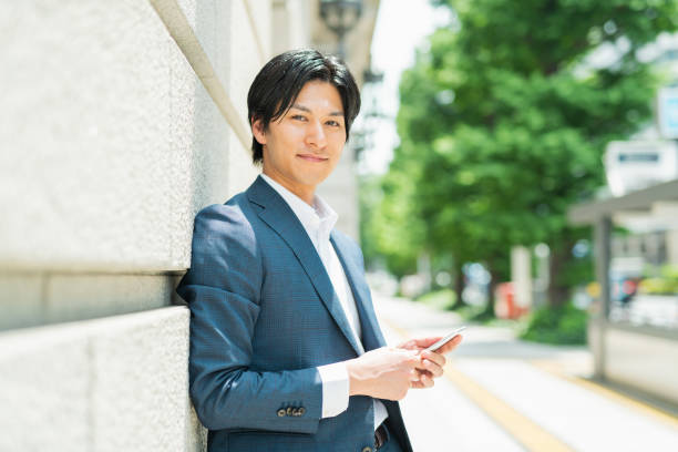 istock Young businessman checking his smartphone by the building 1726661693