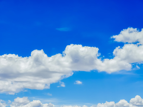 Blue sky with fluffy white clouds.