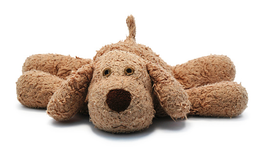 Isolated (pure white background) toy dog, collapsed on the floor.