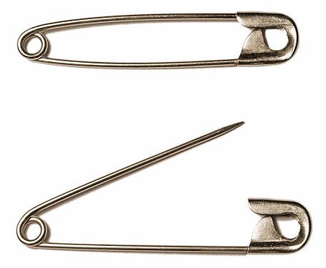 Couple of safety pins. One open and one closed.