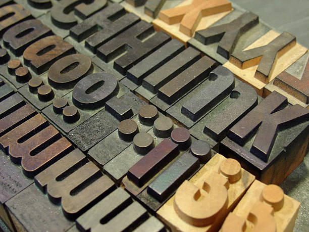 movable type "wooden and metal type pieces. focus is towards the lower part of the image, around the semicolons and exclamation marksTake a look at other images from this series:" printing plate photos stock pictures, royalty-free photos & images