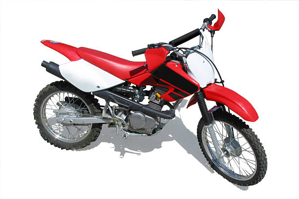 A dirt bike with shadow on a white background Isolated shot of a red dirt bike motorcycle on a white background. rubber shock mount stock pictures, royalty-free photos & images