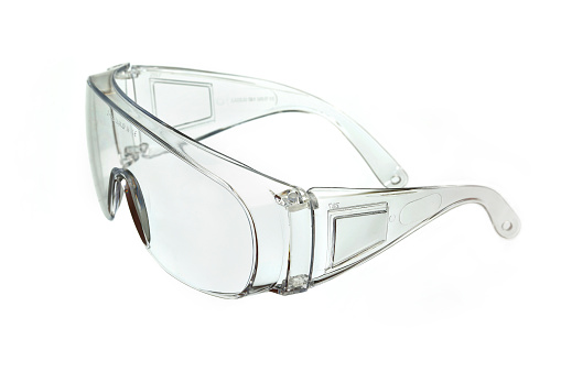 Closeup of swimming goggles on a white background.