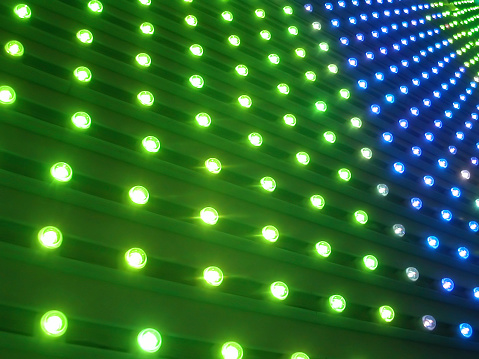 perspective view of a wall of blue and green pin lights