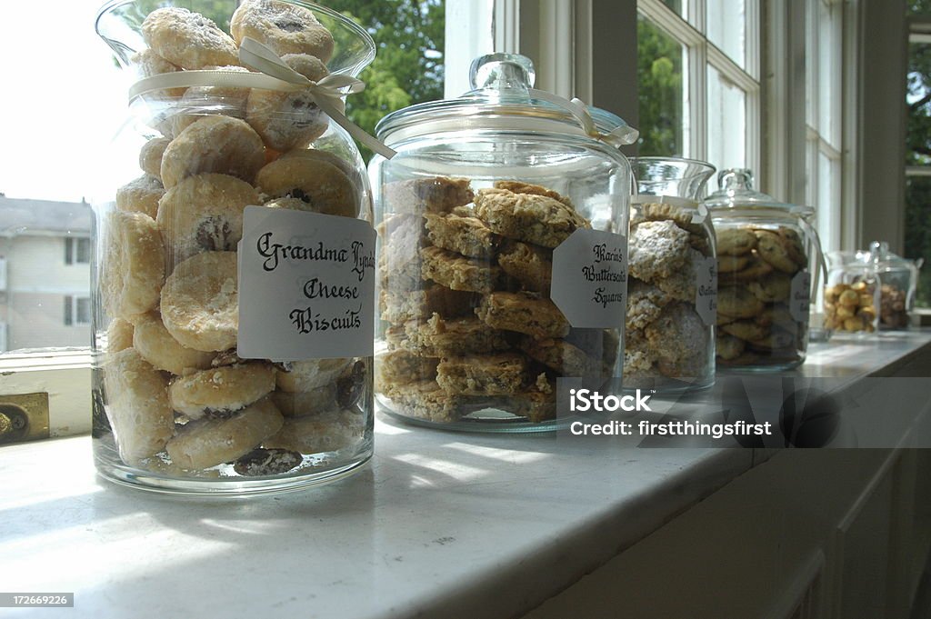 Cookie Jars III Row of clear glass Cookie Jars sitting on a sunny windowsill Cookie Jar Stock Photo
