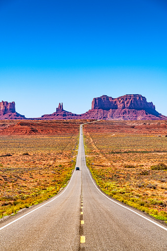 The iconic view along US Highway 163 in Utah leading south toward the buttes of Monument Valley, Arizona.