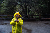 Woman in a yellow raincoat in Yosemite Valley, California
