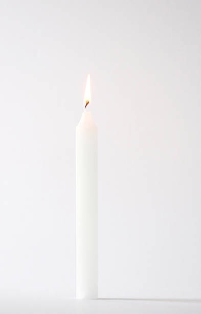 High key white lit candle stock photo
