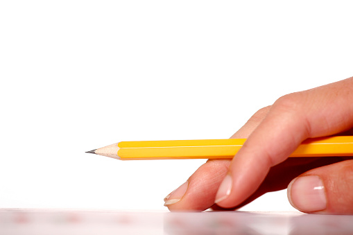 Close-up of hand with a pencil.