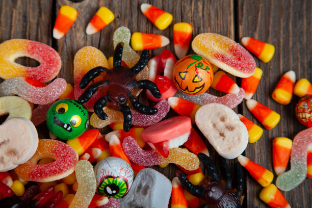 istock Mixed Halloween candy on wooden rustic background 1726712959