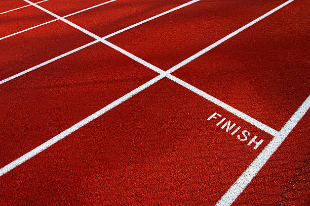 Runners line up for the start of a footrace at a track event.