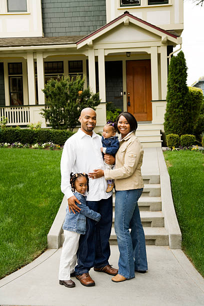 istock Family Standing in Front of House 172671629